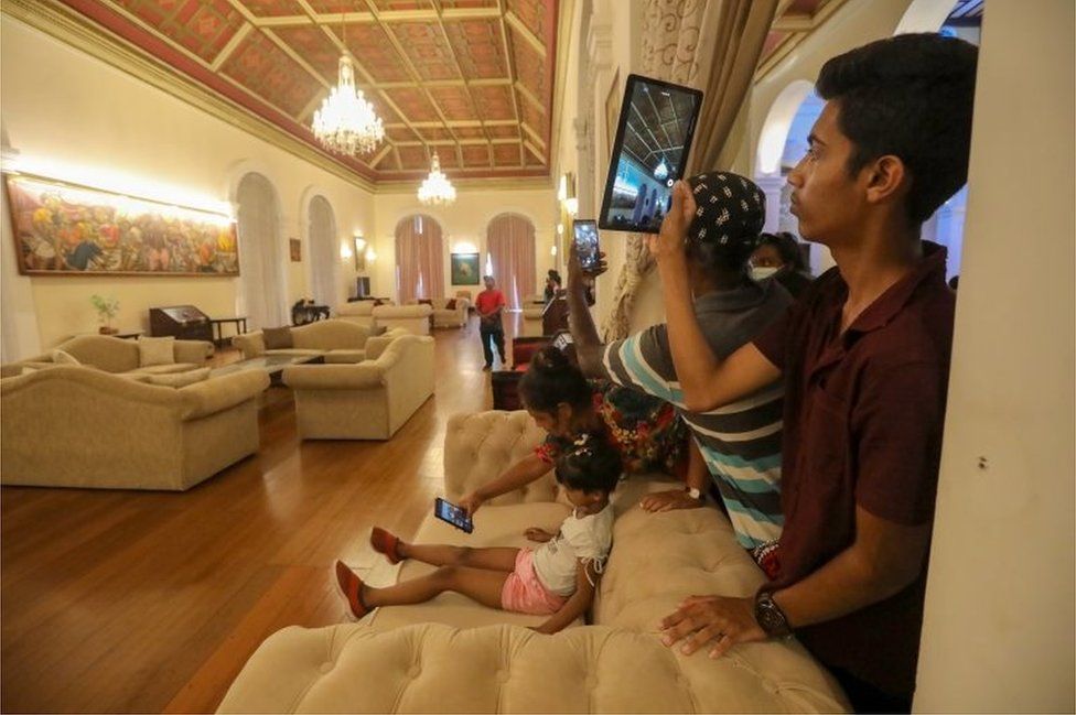 People take photos inside the president's palace, in Colombo, Sri Lanka, 12 July 2022