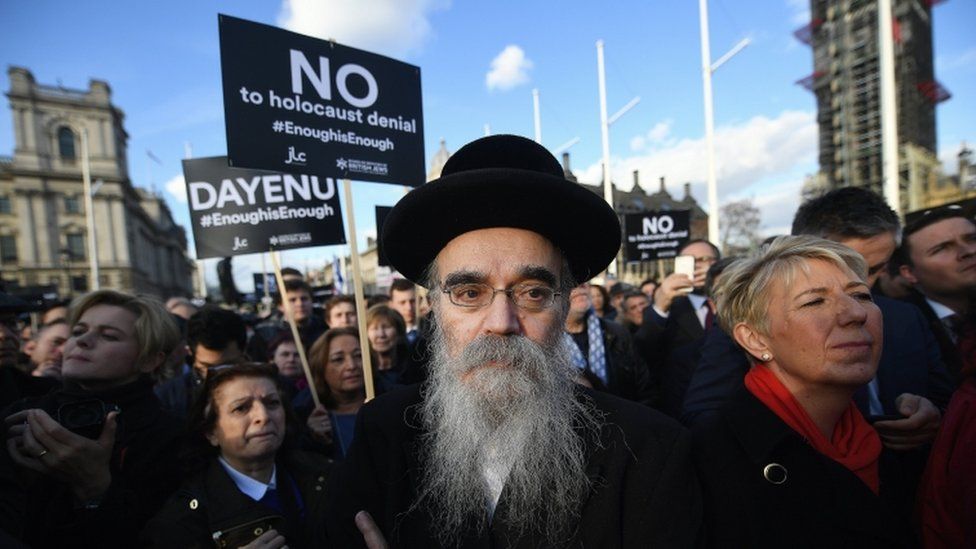 Members of London's Jewish community protest outside The British Houses of Parliament in London