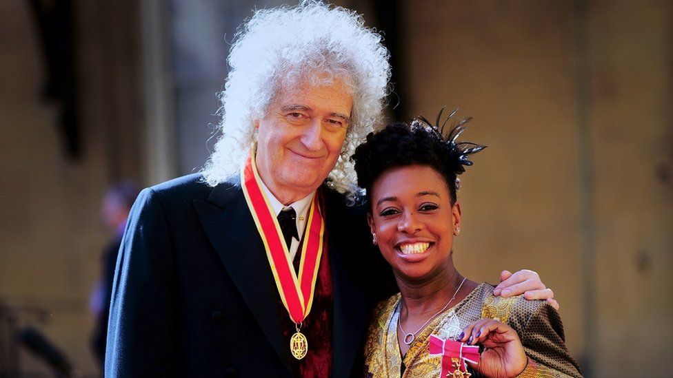 Brian May with saxophonist YolanDa Brown after being knighted