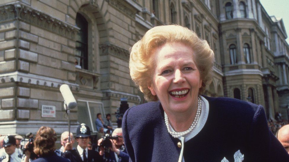Margaret Thatcher leans out of a car at the start of her third term.