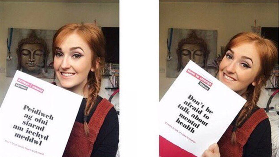 Laura Burton holding up a leaflet about mental health