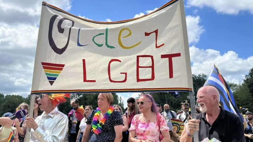 People with an LGBT Pride banner