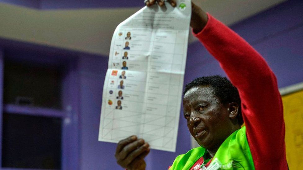 An electoral commission official counts ballots at a polling station in Nairobi
