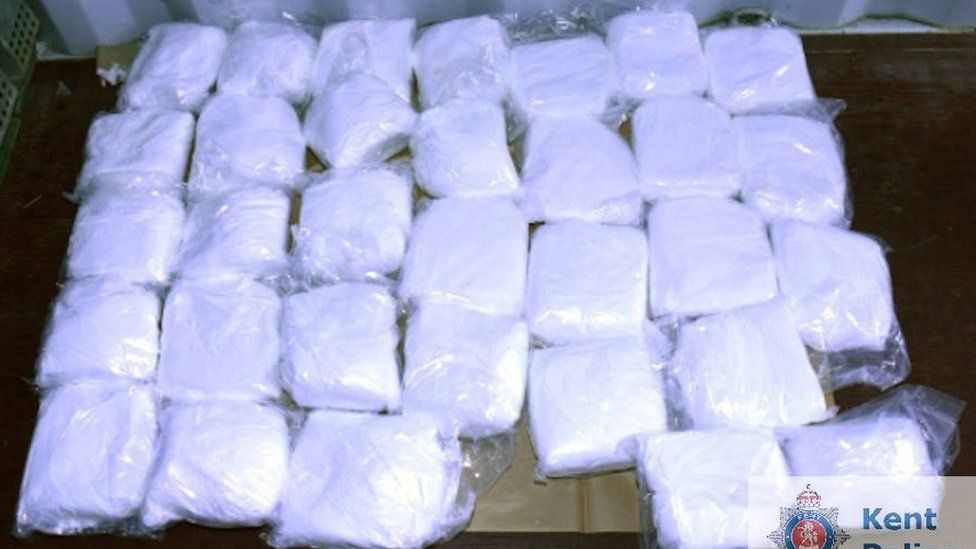 Packets of white powder lined up for a police photo