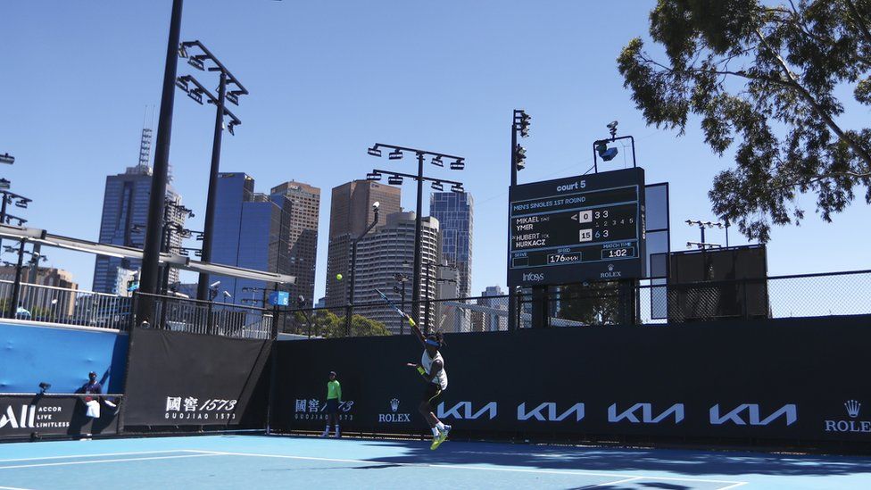 A tennis player serves during a match at the Australian Open in Melbourne