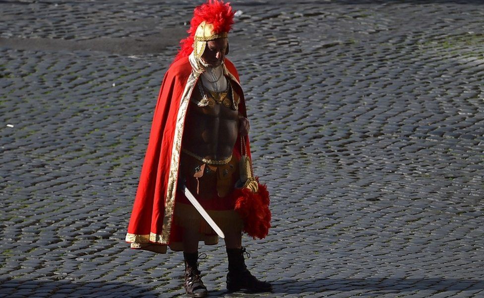 A man dressed as a Roman Centurion waits for tourists near the Ancient Forum on 19 November, 2015 in Rome