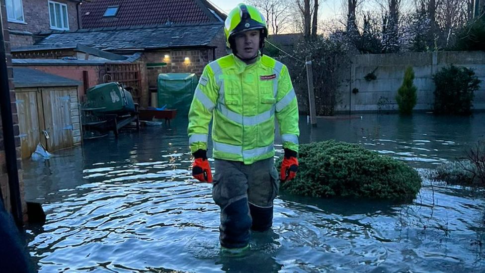 Firefighter in flood water