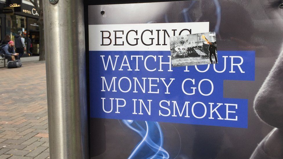 An anti-begging poster which says "Begging: Watch your money go up in smoke"