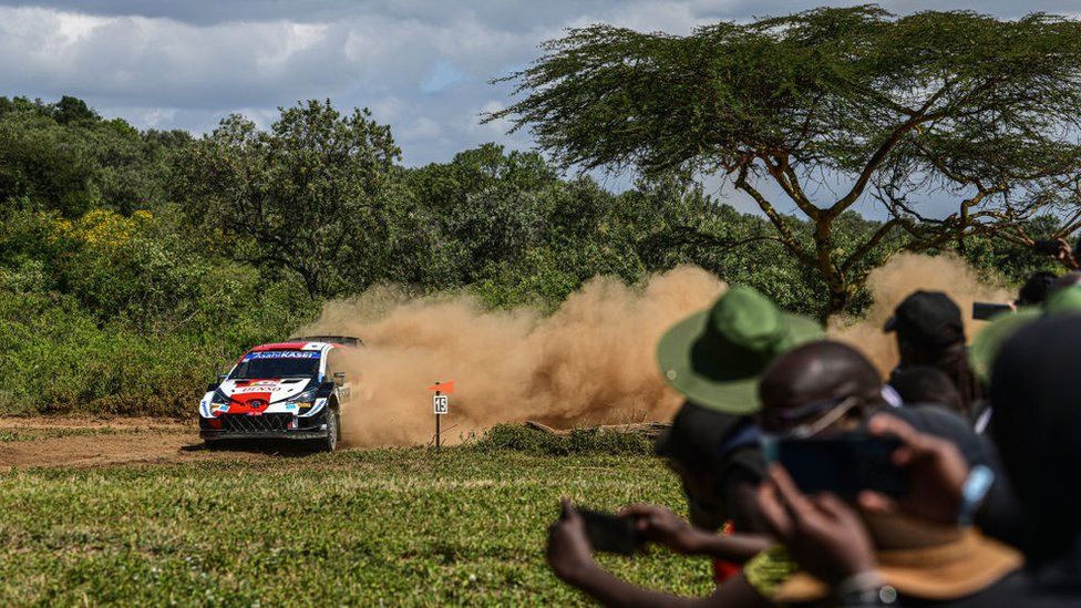 Spectators watch Finnish duo of Kalle Rovanpera and Jonne Halttunen in the shakedown of the Safari Rally in Kenya - Wednesday 23 June 2021