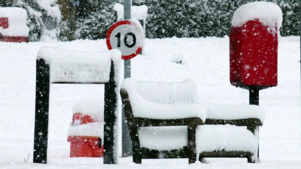 Snow on park bench