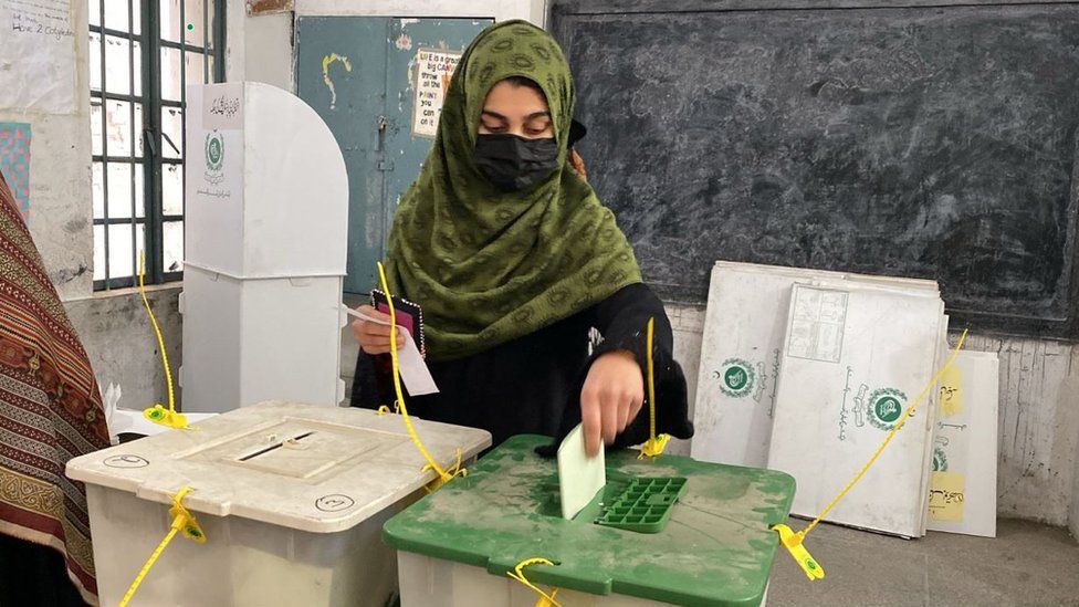 A woman casts her vote in Peshawar