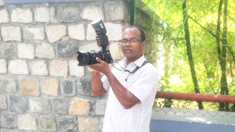 Ravindran with a camera in his hand