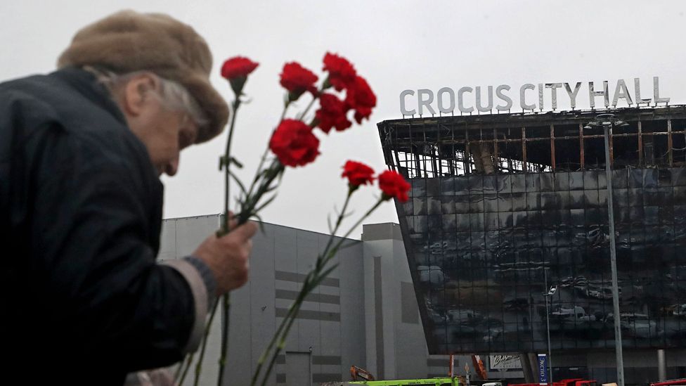 People mourn and bring flowers at the Crocus City Hall concert venue following a terrorist attack in Krasnogorsk, outside Moscow, Russia, on 24 March 2024