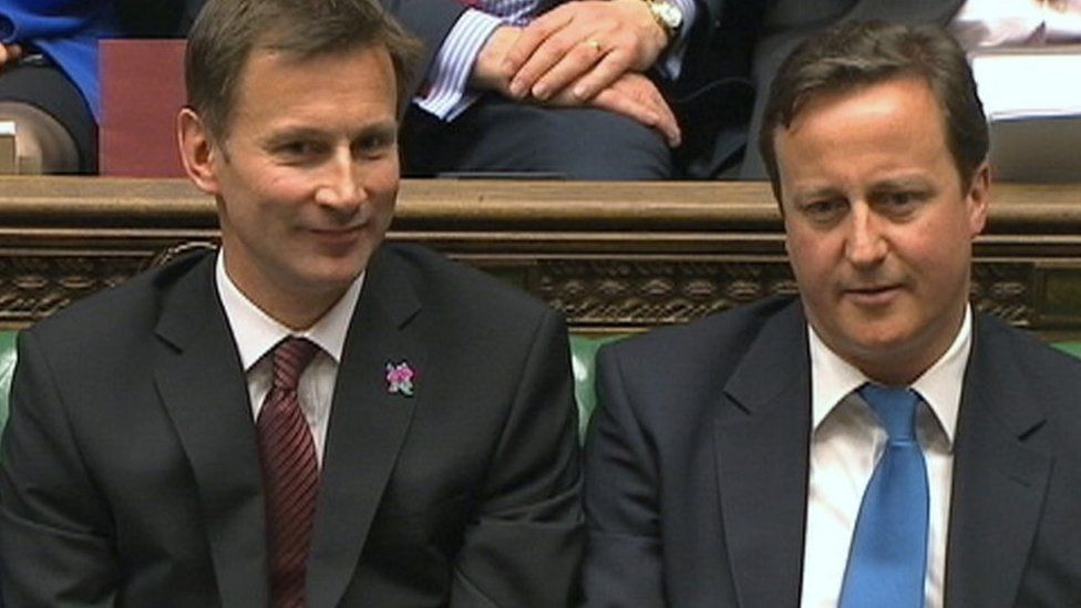 Jeremy Hunt, Britain's Culture Secretary, sits next to then Prime Minister David Cameron