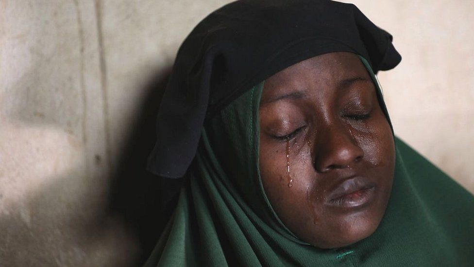 A crying mother whose two daughters were abducted