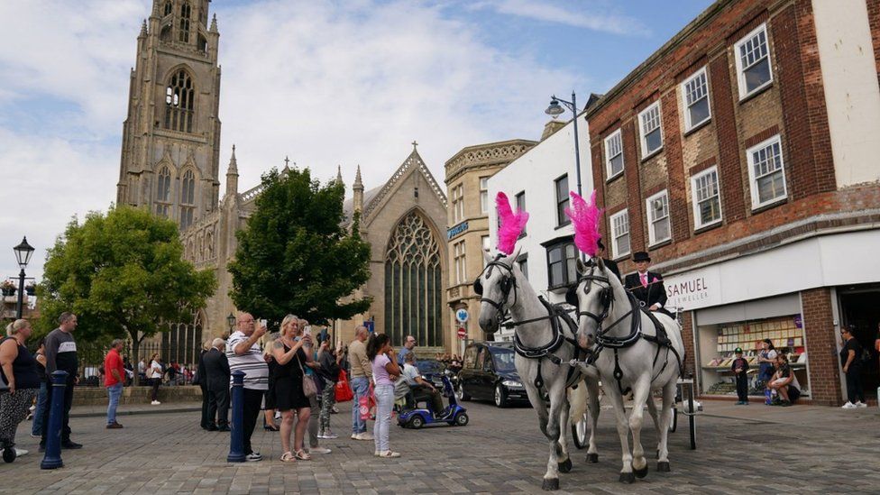 The coffin was driven through the town at about 11:30 BST