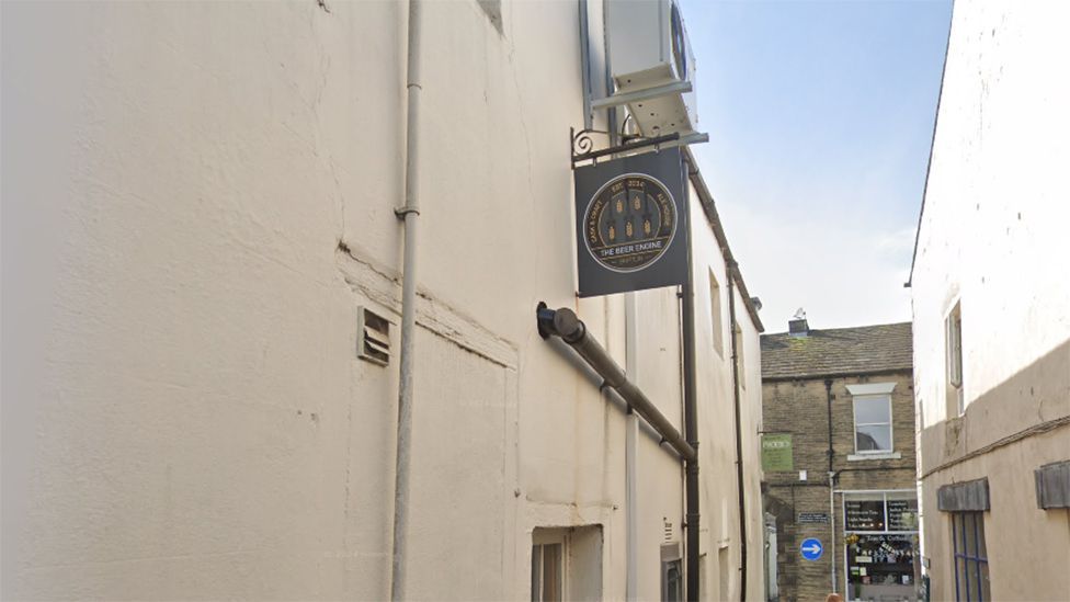 Side view of The Beer Engine on Albert Terrace in Skipton with the pub sign hanging above a doorway.