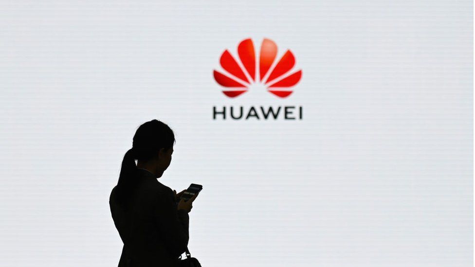 Woman in front of Huawei logo