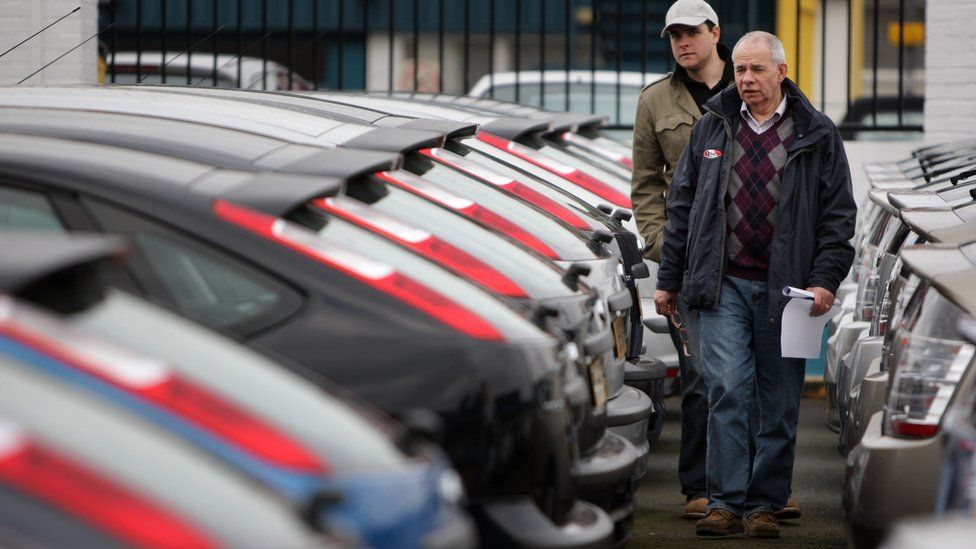 customers at car dealership