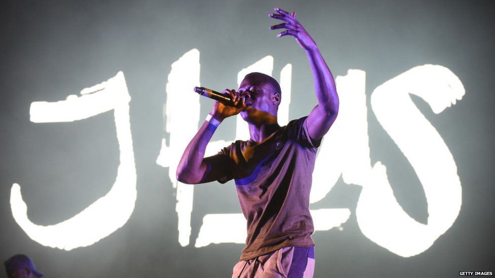 This is a photo of J HUS performing.