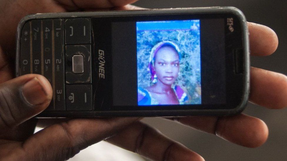 Yana Galang, the mother of Rifkatu Galang, one of the abducted Chibok girls, holds a phone with a picture of her daughter during an interview in Lagos on 5 April 2016