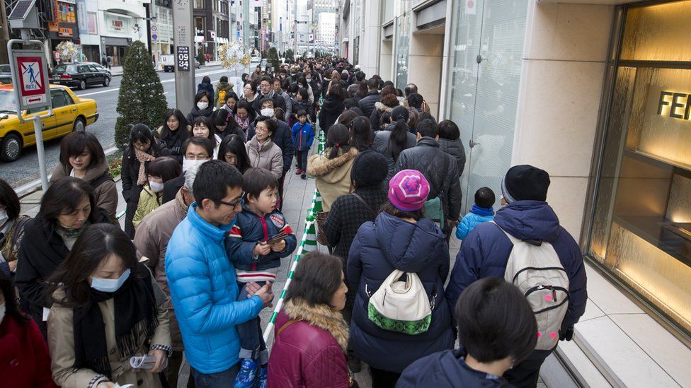 People wait in a queue line for the gate of Matsuya Ginza Department store to purchase a Fukubukuro