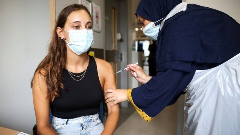 A woman getting the Pfizer jab