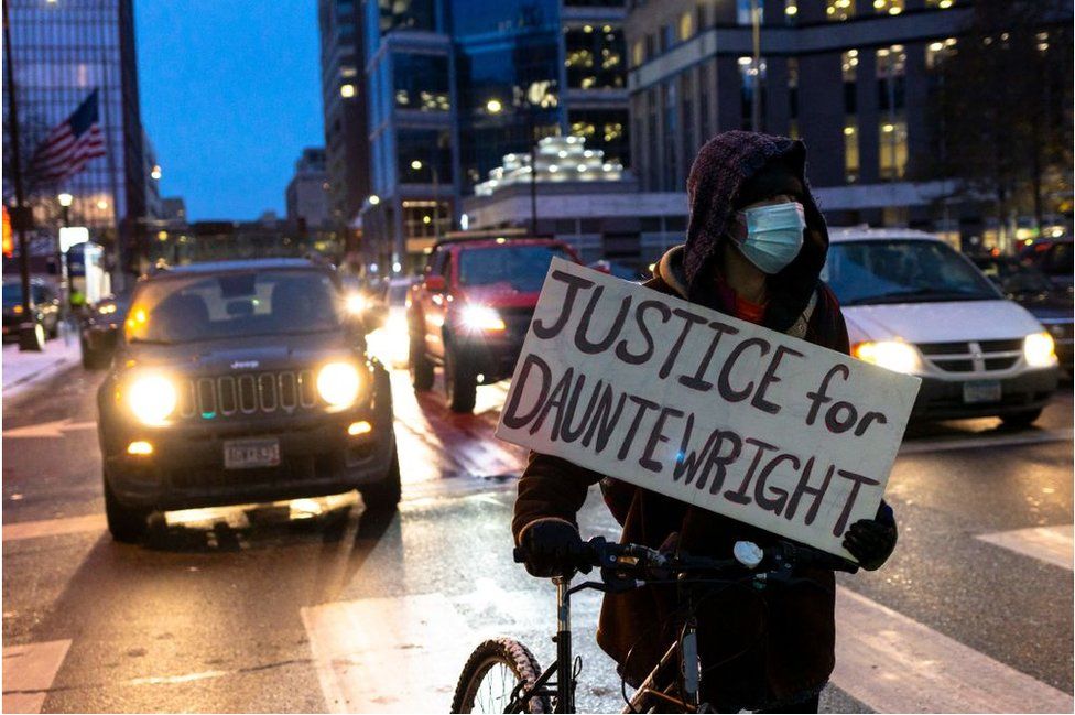 A protester holds a Justice for Daunte Wright sign