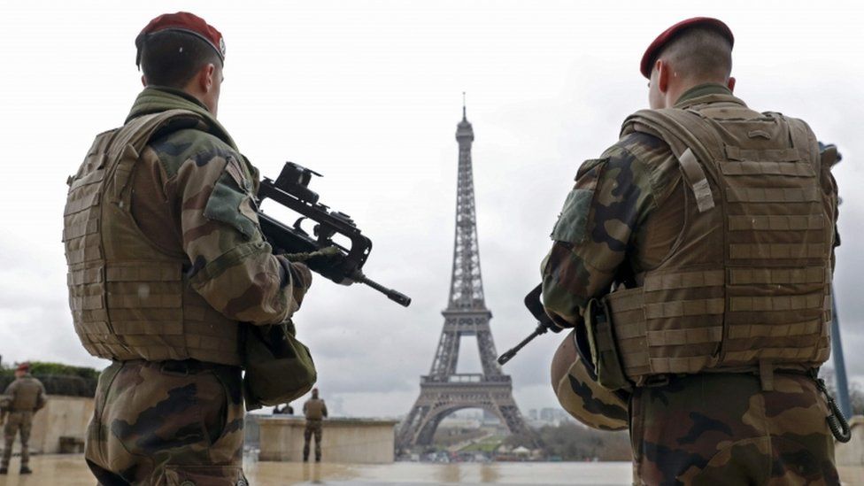 French paratroopers patrol near the Eiffel Tower in Paris (March 2016 picture)