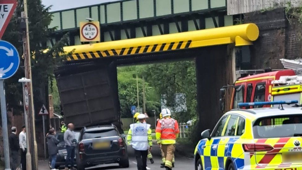 lorry wedged under bridge