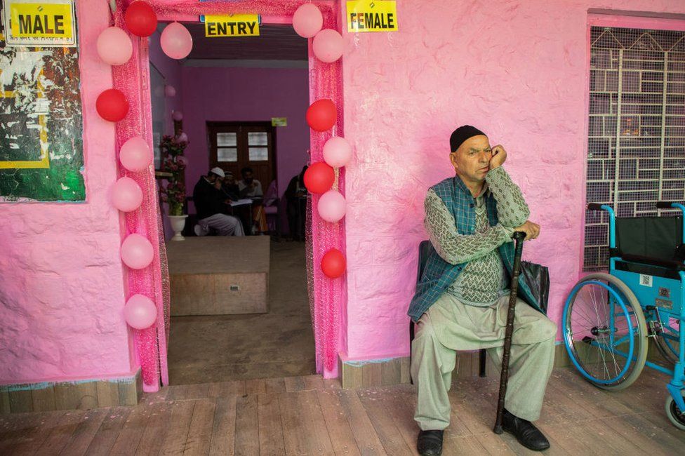 An elderly man waits outside a polling station to cast his vote during the first phase of the Lok Sabha, or lower house, of the Indian parliamentary elections in Banihal, an area in Ramban district of Udhampur parliamentary constituency.