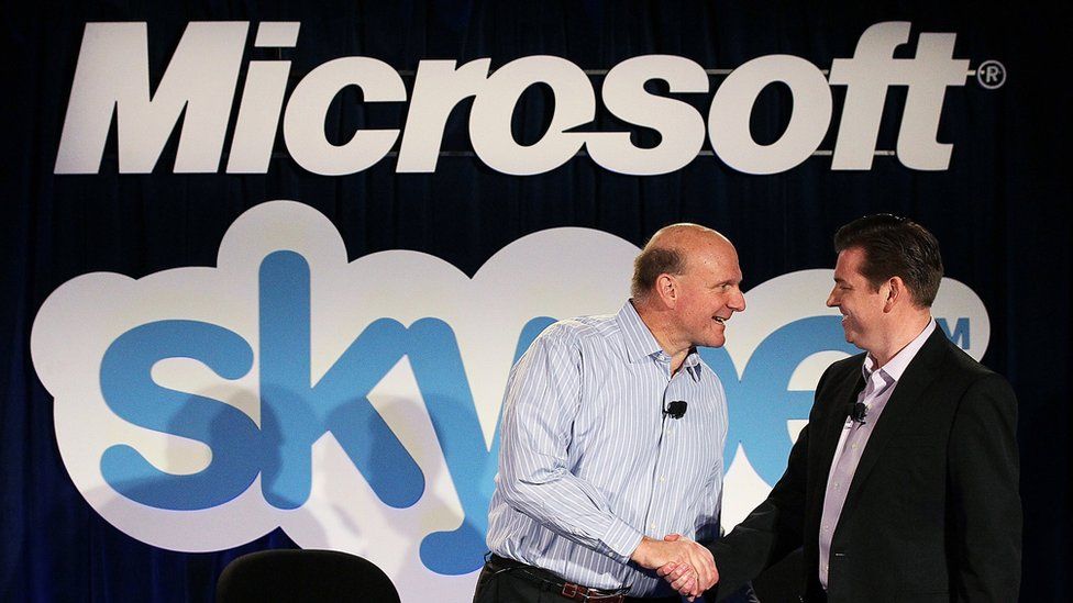 Steve Balmer shakes hands with then-Skype chief executive Tony Bates at a 2011 conference announcing Microsoft's acquisition