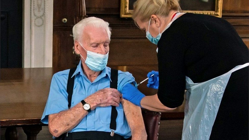 Chelsea Pensioner Bob (Robert) James Sullivan is injected with the Pfizer/BioNTech Covid-19 vaccine by Pippa Nightingale