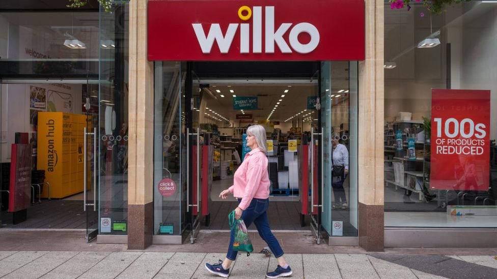 Woman walks past Wilko shop