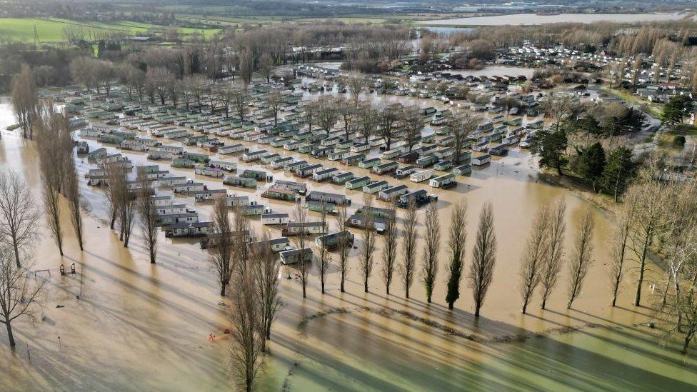 Holiday homes at the Billing Aquadrome in Northampton surrounded by water due to rising water caused by Storm Henk.