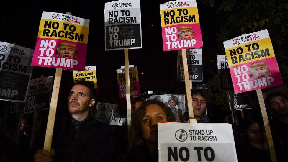 "No to racism, no to Trump" banners