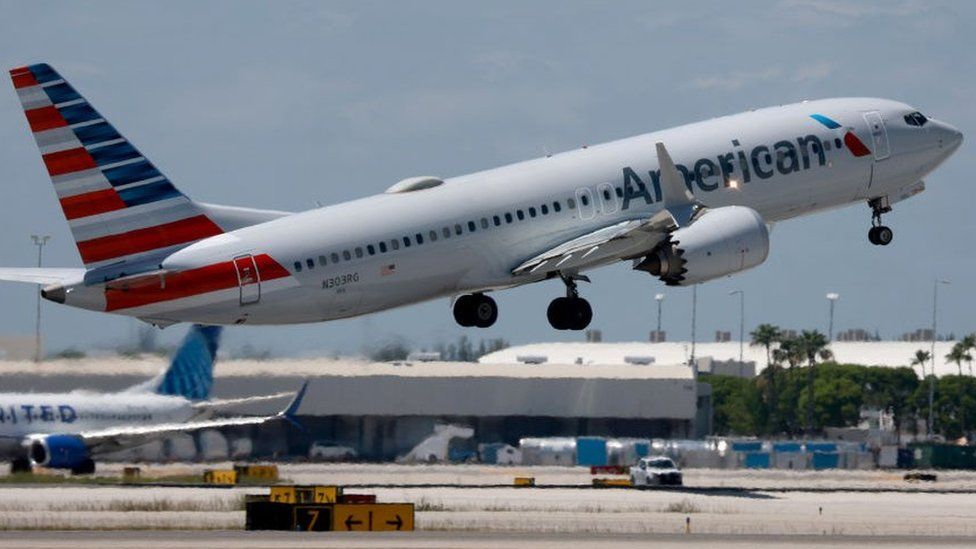 An American Airlines plane leaves a runway