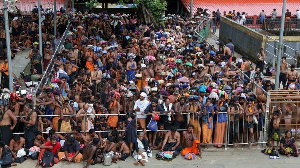 Hindu devotees wait inside the premises of the Sabarimala temple in Pathanamthitta district in the southern state of Kerala