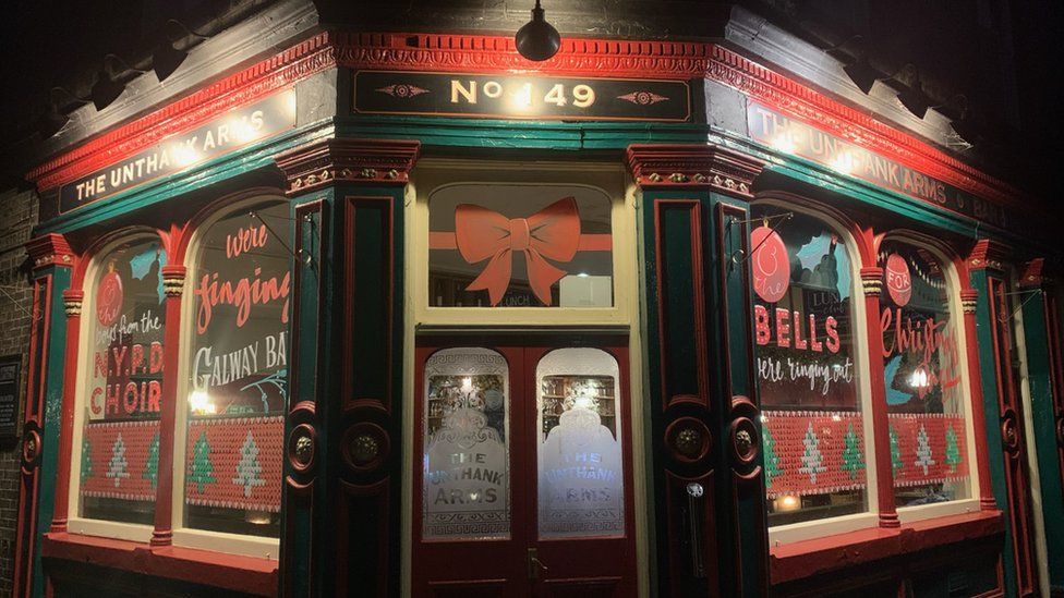 Pub windows with Fairytale of New York painted on them