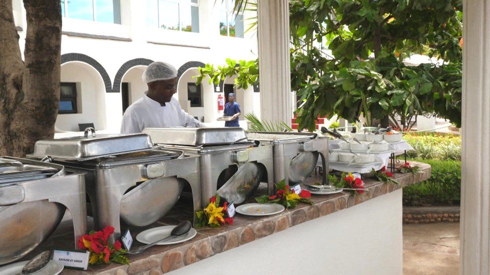 Hotel staff catering a meal at one of Sunbird Tourism's resorts in Malawi
