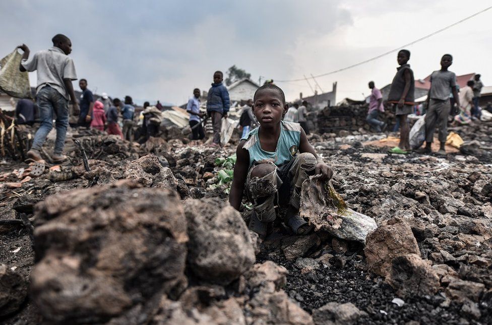 Child sits on the rubble