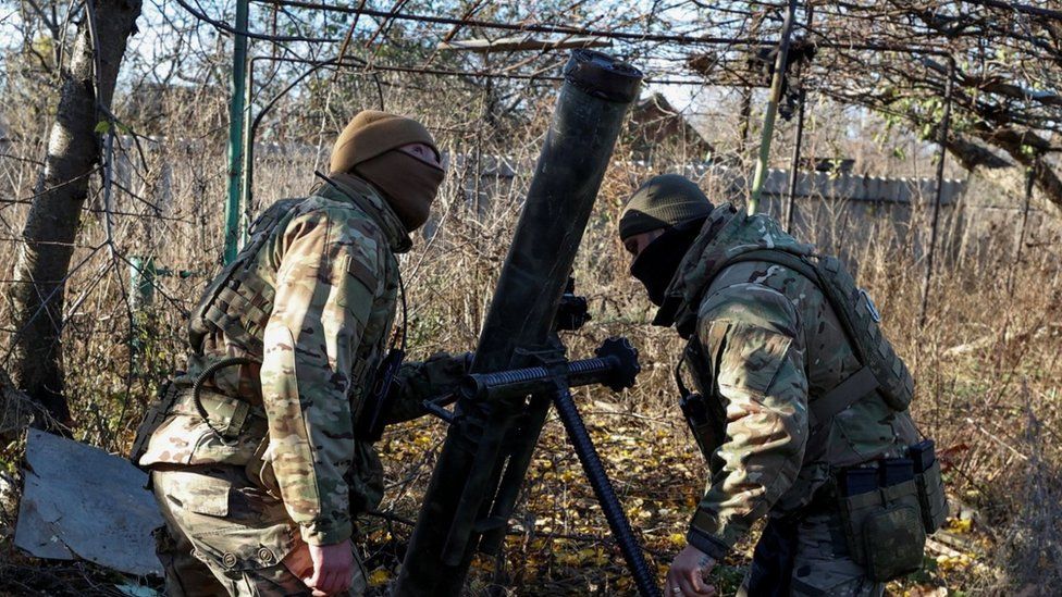 Members of Ukraine's National Guard Omega Special Purpose unit prepare a mortar before fire toward Russian troops in the front line town of Avdiivka
