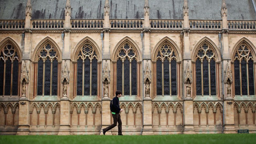 Student outside a building at University of Cambridge