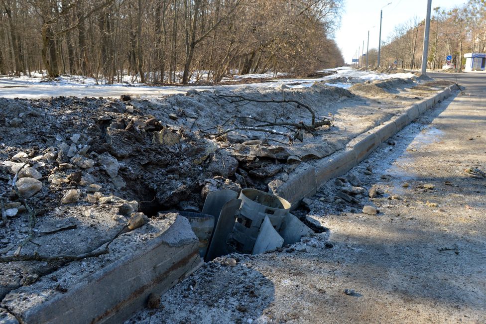A rocket embedded in a road after recent shelling on the northern outskirts of Kharkiv on 24 February 2022