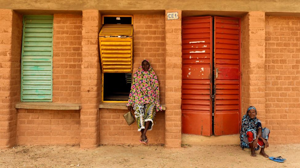 People outside a school designed by Diébédo Francis Kére in Gando, Burkina Faso - Saturday 4 June 2022