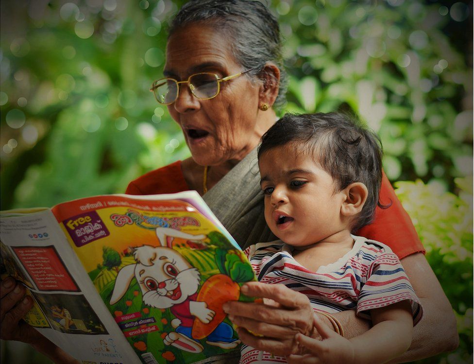 A grandmother reads to her grandson