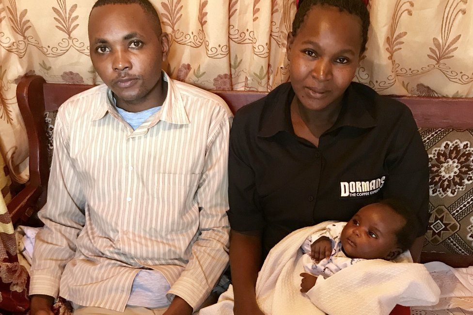 Susan Mbula and her husband hold baby Peace