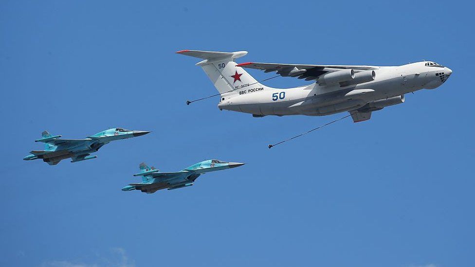 An IL-78 Midas jet flies alongside two tactical bombers