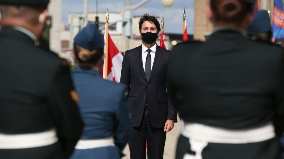 Canada's Prime Minister Justin Trudeau listens to the National Anthem prior to the Speech from the Throne on September 23, 2020, in Ottawa, Canada