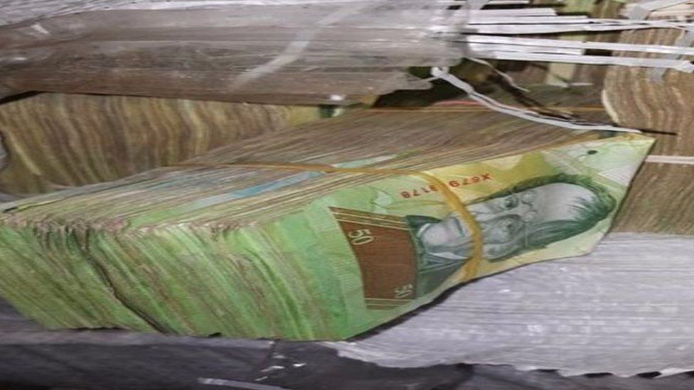A photo shows some of the bills seized in Paraguay.